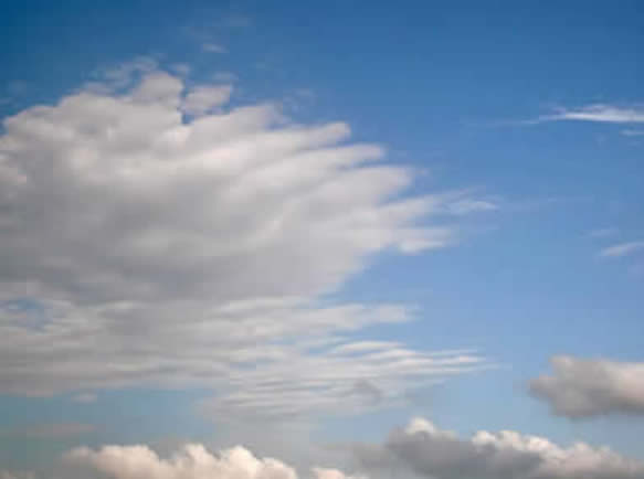 photograph of white whispy clouds in a blue blue sky